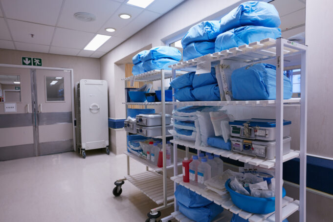 Shelves stocked with medical supplies and sterilized equipment in a hospital's Central Sterile Supply Department (CSSD).